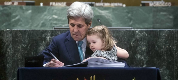 Former US Secretary of State John Kerry, accompanied by his grand-daughter, signs the Paris Agreement at UN headquarters in April 2016. — Courtesy photo