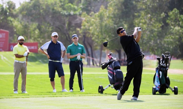 Ali Saif Bin Sumadia of the UAE plays a shot as Padraig Harrington of Ireland watches on during the pro am ahead of the Abu Dhabi HSBC Championship at Abu Dhabi Golf Club on Wednesday in Abu Dhabi, United Arab Emirates. (Photo by Ross Kinnaird)