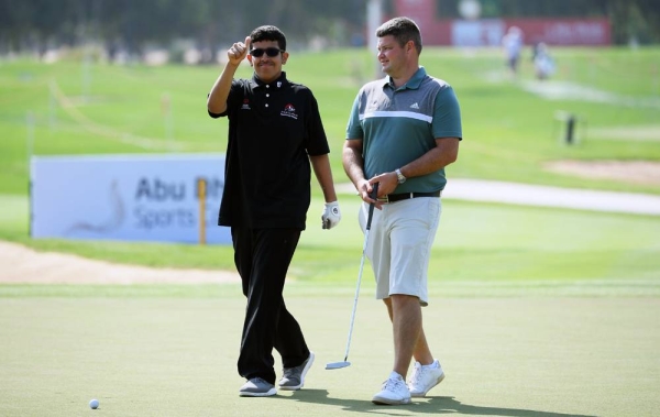 Ali Saif Bin Sumadia of the UAE plays a shot as Padraig Harrington of Ireland watches on during the pro am ahead of the Abu Dhabi HSBC Championship at Abu Dhabi Golf Club on Wednesday in Abu Dhabi, United Arab Emirates. (Photo by Ross Kinnaird)