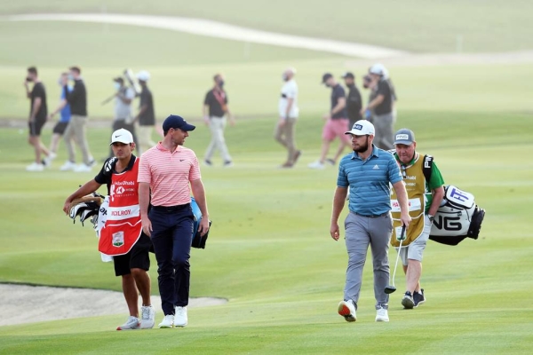 Rory McIlroy of Northern Ireland and Tyrrell Hatton of England walk on the 18th hole during Day Three of the Abu Dhabi HSBC Championship at Abu Dhabi Golf Club on Saturday in Abu Dhabi, United Arab Emirates. (Photo by Ross Kinnaird)