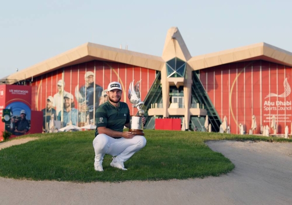 Tyrrell Hatton of England poses for a photograph with the trophy following victory during Day 4 of the Abu Dhabi HSBC Championship at Abu Dhabi Golf Club on Sunday in Abu Dhabi, United Arab Emirates. (Photo by Warren Little)