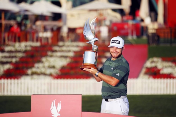 Tyrrell Hatton of England poses for a photograph with the trophy following victory during Day 4 of the Abu Dhabi HSBC Championship at Abu Dhabi Golf Club on Sunday in Abu Dhabi, United Arab Emirates. (Photo by Warren Little)
