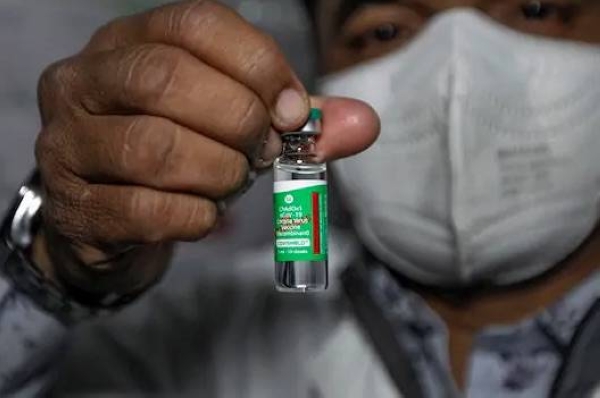 A health worker shows the Covishield vaccine, after arrival of the first batch of the vaccines from the Serum Institute of India at the Civil Hospital, in Ahmedabad. — courtesy PTI