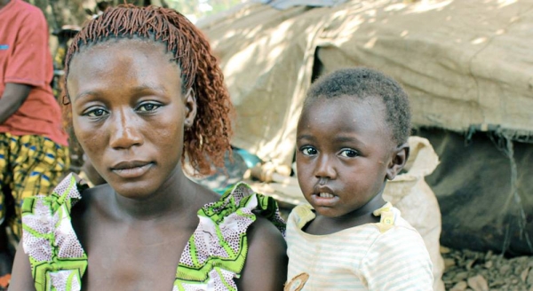 

A refugee mother from Central African Republic sits with her children beside a makeshift shelter in Ndu village, the Democratic Republic of the Congo. — courtesy UNHCR/Fabien Faivre