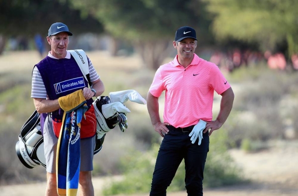 Paul Casey and his caddie after he had chipped in for a birdie on the 17th hole during the third round of the Omega Dubai Desert Classic at Emirates Golf Club on Saturday in Dubai, United Arab Emirates. (Photo by Andrew Redington)
