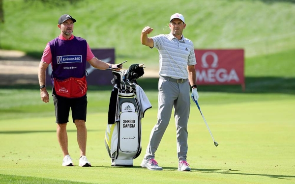 Paul Casey and his caddie after he had chipped in for a birdie on the 17th hole during the third round of the Omega Dubai Desert Classic at Emirates Golf Club on Saturday in Dubai, United Arab Emirates. (Photo by Andrew Redington)