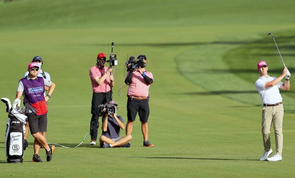 Paul Casey and his caddie after he had chipped in for a birdie on the 17th hole during the third round of the Omega Dubai Desert Classic at Emirates Golf Club on Saturday in Dubai, United Arab Emirates. (Photo by Andrew Redington)