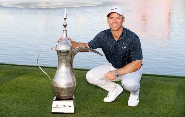Paul Casey of England with the winner's trophy on the 18th green after the final round of the Omega Dubai Desert Classic at Emirates Golf Club on Sunday in Dubai, United Arab Emirates. (Photo by Ross Kinnaird)