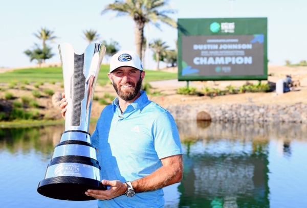 Dustin Johnson of the USA with the winners trophy after the final round of the Saudi International powered by SoftBank Investment Advisers at Royal Greens Golf and Country Club on Sunday in King Abdullah Economic City, Saudi Arabia. (Photo by Ross Kinnaird)