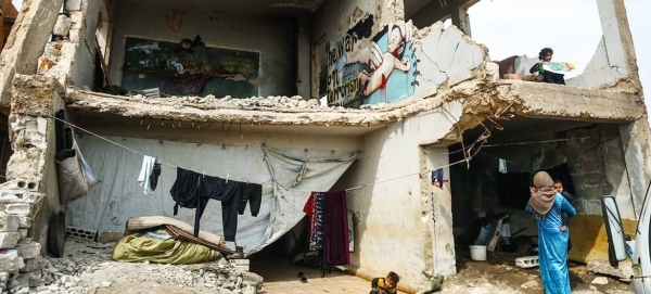 Sixteen families live in a damaged school in the Syrian town of Binish. — courtesy OCHA