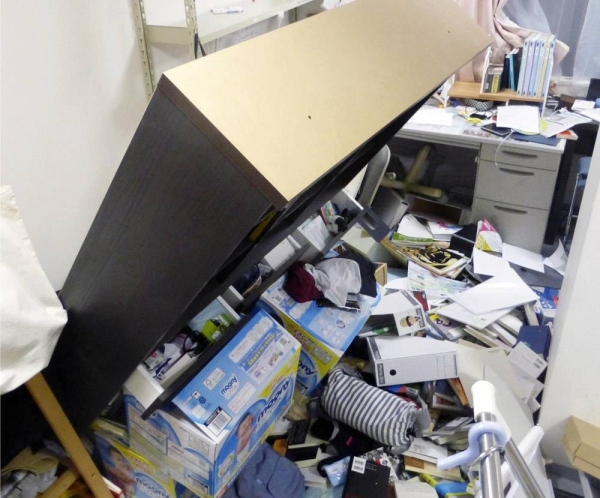 A bookshelf is seen tipped over at a home in Koriyama, Fukushima Prefecture, late Saturday after a powerful earthquake struck the region. — courtesy Kyodo