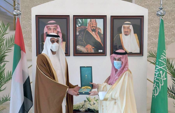 Minister of Foreign Affairs Prince Faisal Bin Farhan presented here Monday King Abdulaziz Second Class Scarf to Sheikh Shakhbout Bin Nahyan Bin Mubarak Al Nahyan.
