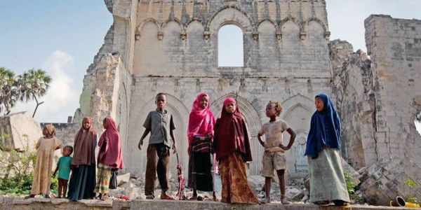 File photo shows children standing before the remains of Mogadishu cathedral, built by the Italian colonial authorities in Somalia. — courtesy IRIN/Kate Holt