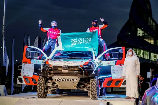 Saudi Arabia’s Yazeed Al Rajhi and co-driver Michael Orr, with Emirates Motorsports Organization CEO Mahir Badri.