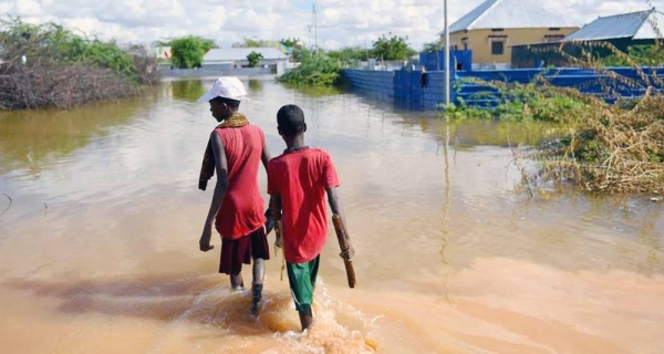 Young boys walk through a section of a flooded residential area in Belet Weyne, Somalia. — courtesy UN Photo/Ilyas Ahmed