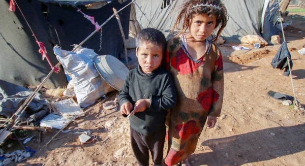 Children stand outside the tent where they live in a remote desert camp in southern rural Homs, Syria. — courtesy UNICEF/Abdulaziz Aldroubi