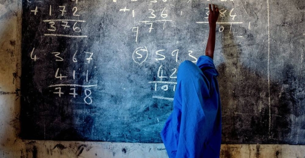 A young girl writes on a chalkboard at a primary school in Nigeria. — courtesy UNICEF/Apochi Owoicho