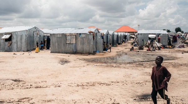 
A child walks in front of shelters at an IDP camp in Maiduguri, the capital of Borno state in northeast Nigeria. — courtesy UNICEF/KC Nwakalor