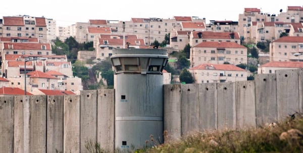 The Separation Wall in the occupied Palestinian Territory and behind it an Israeli settlements. — courtesy Photo/Ryan Rodrick Beiler