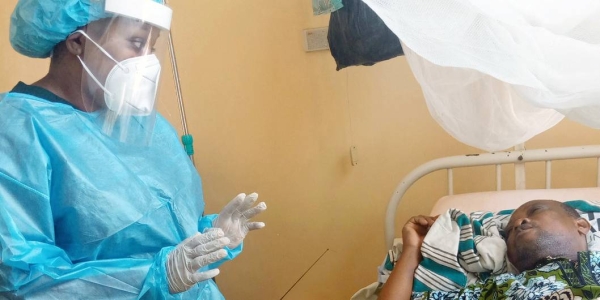 Dr. Babio visits a patient admitted to hospital in Benin. — courtesy Hermès Amoussouvi