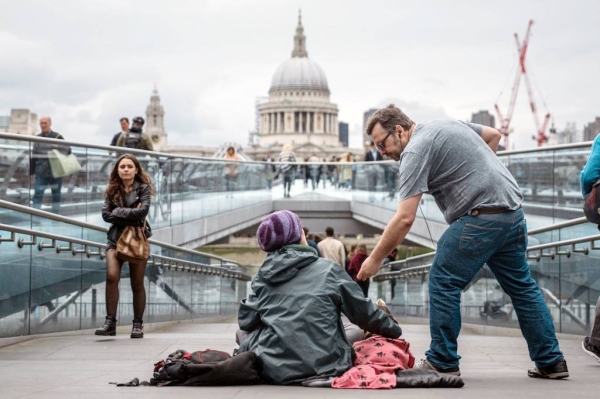 A homeless woman begs for money in the center of London, United Kingdom. — courtesy Unsplash/Tom Parsons