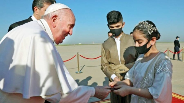 Pope Francis is greeted by an Iraqi woman upon his arrival at Irbil airport. — courtesy Vatican News