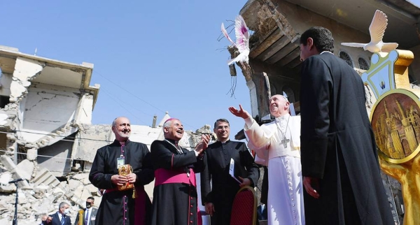 

Pope Francis (center) releases a dove representing peace at the ruins of the Syriac Catholic Church of the Immaculate Conception in Mosul, Iraq. — courtesy Vatican Media