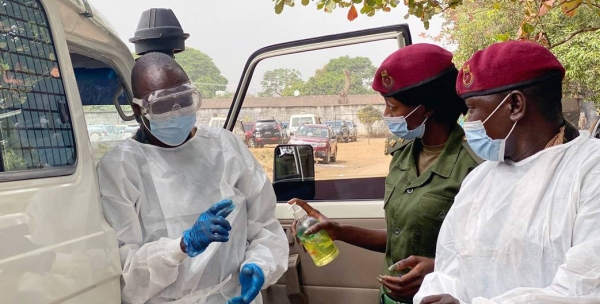 Lt. Matilda Moiwo (center) and her colleagues prepare to collecting a patient suspected of catching COVID-19. — courtesy NaCOVERC/Alpha Daramy