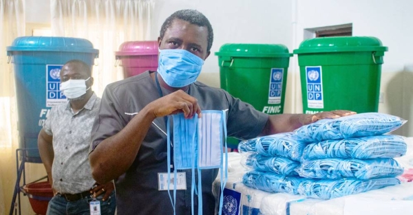 Lt. Matilda Moiwo (center) and her colleagues prepare to collecting a patient suspected of catching COVID-19. — courtesy NaCOVERC/Alpha Daramy