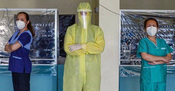 Wearing a full protective suit, a women doctor who leads a group of volunteer medical professionals attending to COVID-19 patients and persons under investigation at a community hospital in the Philippines. — courtesy UN Women/Louie Pacardo