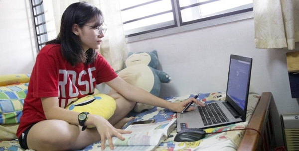 A student at the Sekolah Menengah Kebangsaan Subang Jaya school, studies at home home in Malaysia. The UN independent expert on minority rights says social media is being used with impunity to spread hate, and violence. — courtesy UNICEF/UN0140097/Humphries