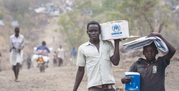

South Sudanese refugees carrying Core Relief Items walk down a road in Bidibidi refugee settlement, Yumbe District, Northern Region, Uganda. — courtesy UNHCR/David AziaUNHCR/David Azia