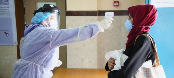 A woman is screened for COVID-19 at a health center in the Gaza Strip. — File courtesy photo