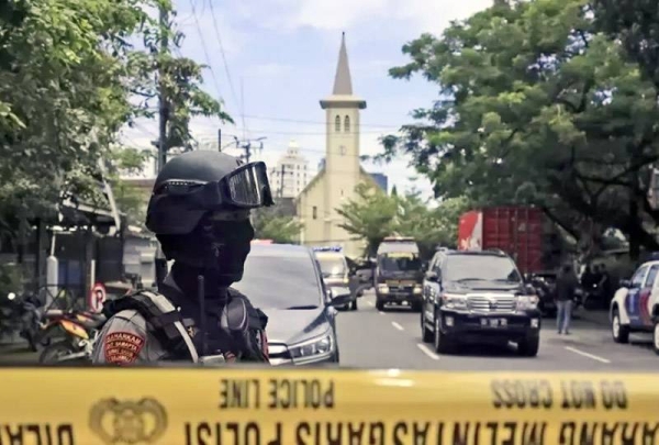 Indonesian police cordon off the area around the Sacred Heart of Jesus Cathedral in Makassar, the capital of South Sulawesi province, after two suicide bombers blew themselves up while trying to enter the church on Sunday.