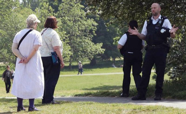 Police are seen warning people not to be complacent as lockdown rules eased on Monday in England. — courtesy photo PA