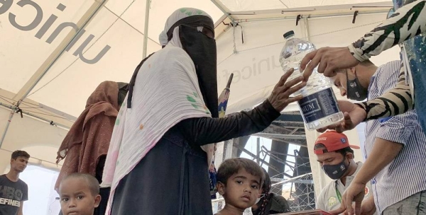 Rohingya volunteers clear debris to reconstruct shelters after the devastating fire at the Kutupalong refugee camp, in Cox’s Bazar, Bangladesh. — courtesy WFP/Mehedi Rahman