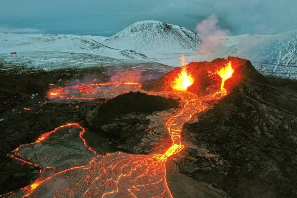 Steam and lava spurted Monday from a new fissure at an Icelandic volcano that began erupting last month.