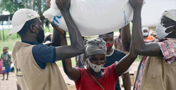 A displaced woman in northern Mozambique receives food aid. — courtesy WFP/Grant Lee Neuenburg