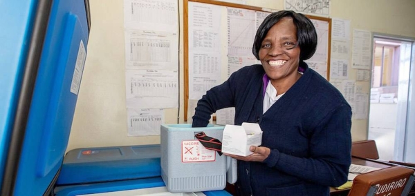 Nurse Merjury Mayoyo stores vaccines in a dedicated solar-powered refrigerator at the Budiriro Clinic in Zimbabwe. — courtesy UNDP/Karin Schermbucker