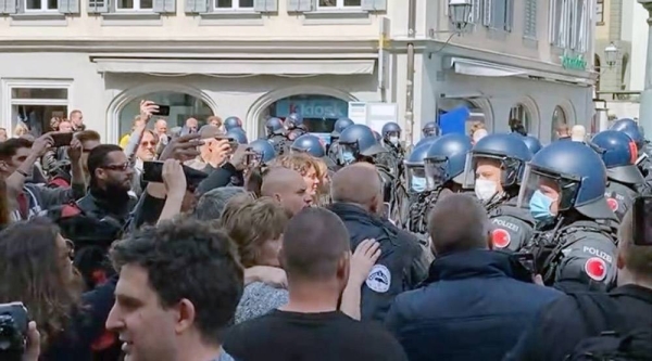 A video grab of Swiss protestors facing up to police in the capital city as many others took to the streets to protest COVID-19 restrictions in other European capitals.