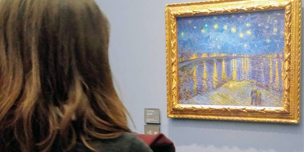 Woman at Musée d'Orsay in Paris gazes at Vincent Van Gogh painting from 1888. — courtesy UN News/Elizabeth Scaffidi