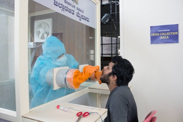 A corona nursing staff collecting the swab sample from a suspected covid19 patient in Mysore city hospital of Karnataka state in India.