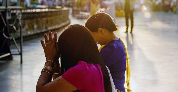 File photo shows two women pray at a temple in Yangon, Myanmar. — courtesy Unsplash/Matteo Massimi