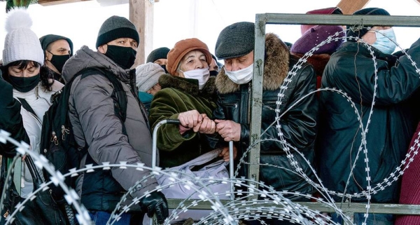In Ukraine, residents wait in line at the Novotroitske crossing point. — courtesy UNOCHA/Yevhen Maloletka