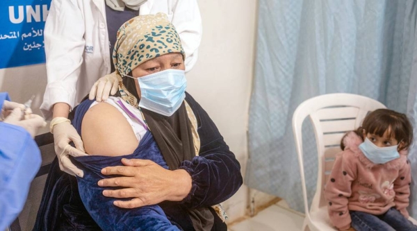 A Syrian refugee receives a COVAX-supplied COVID-19 vaccine in Zaatari refugee camp in Jordan. — courtesy UNICEF/Moises Saman