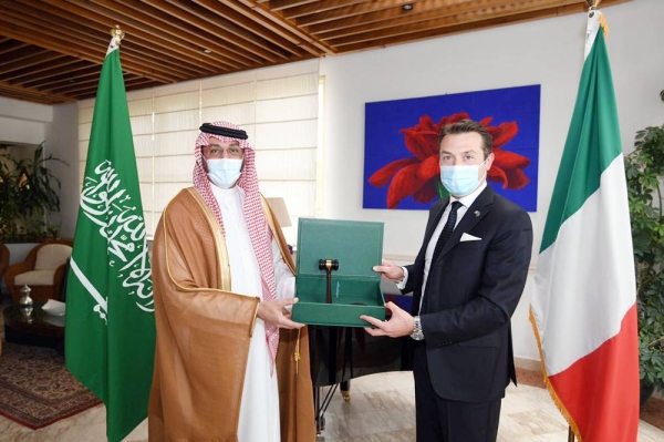 Saudi G20 Sherpa Abdulaziz Al-Rasheed hands over the ceremonial gavel to Chargé d'Affaires at the Italian Embassy Valreio De Paroles at the Italian Embassy in Riyadh.