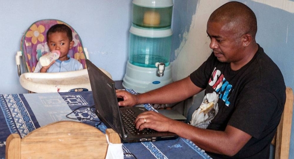 On April 14, 2020 in Yerevan in Armenia, Danny, 7, sits at a computer as his father Arthur Gevorgyan works. — courtesy UNICEF/Arthur Gevorgyan