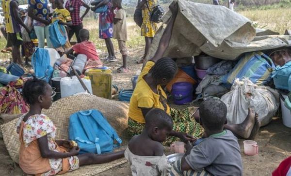 A woman and her young sons stand in front of their shelter in a camp for displaced people in Baboua, Central African Republic. — courtesy UNICEF/Florent Vergnes