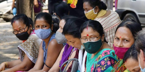 People wait for a COVID-19 vaccination at a state dispensary in Guwahati, India, on April 29, 2021. — courtesy UNICEF/Biju Boro