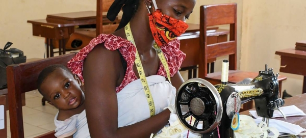 A woman in Guinea turns her sewing skills into mask-making during the COVID-19 crisis in this courtesy file photo. 